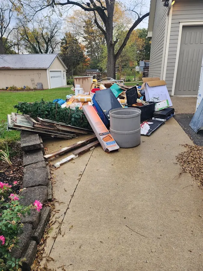 Dumpster being loaded with debris for 30 Yard Dumpster Rental in Potterville